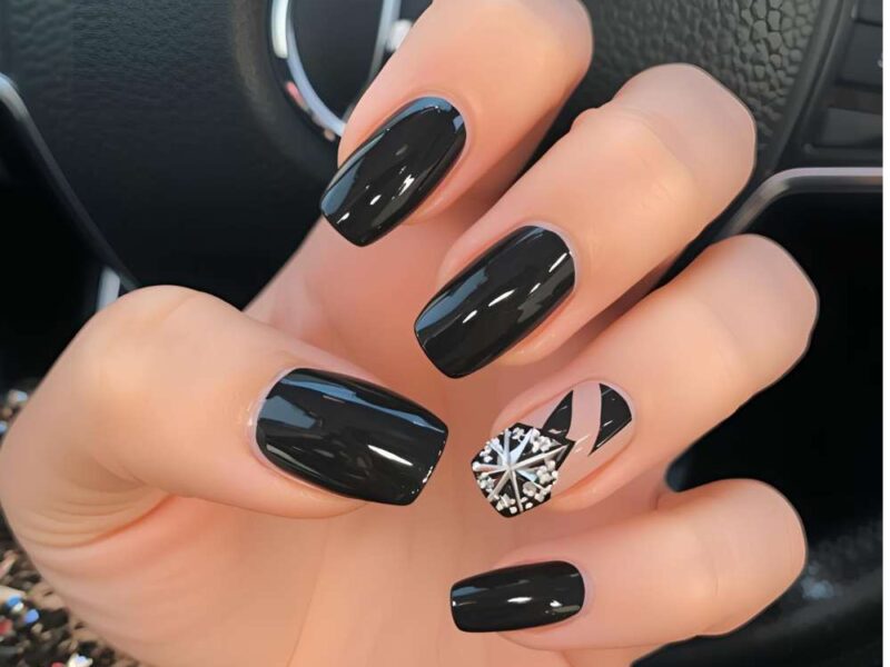 Black-New-Year-nail- design-featuring- glossy-black-nails-with-one-accent-nail- decorated-with-festive -nail-art.