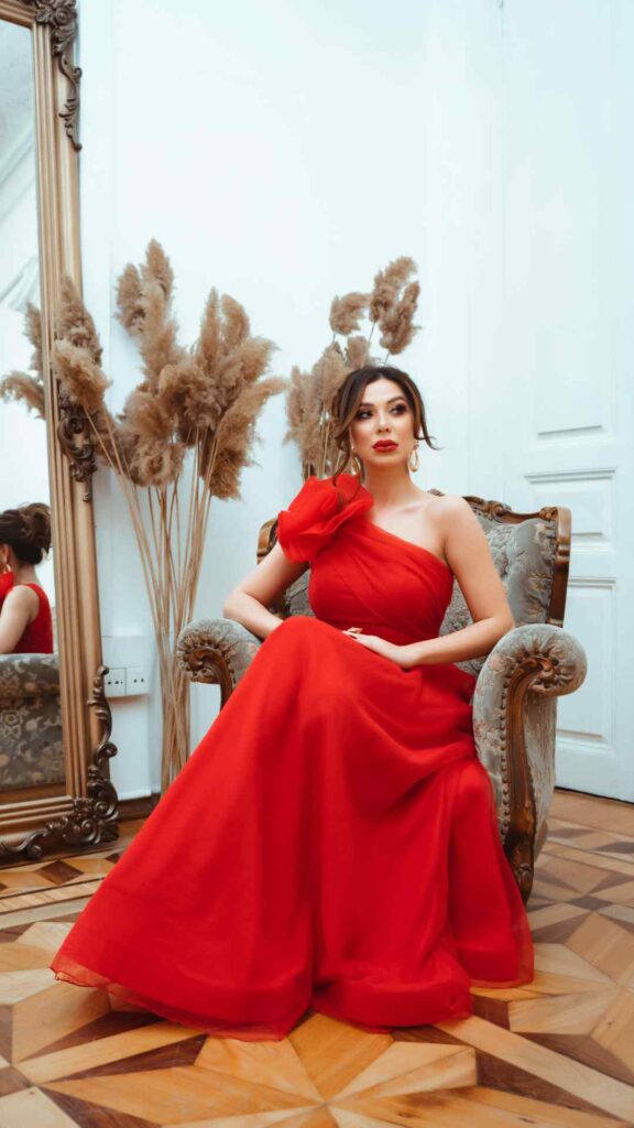 Beautifully-dressed-woman-in-a-red- gorgeous-gown-sitting-gracefully- showcasing-how-to-be-intentional- about-our-Valentine’s-Day-outfits-as-a-woman.