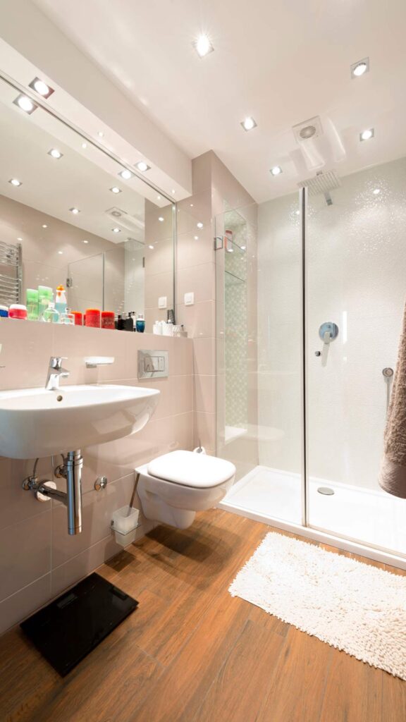 finished-touch-of-bathroom-makeover-with-mirror-flower-tissue-holder-air-freshener-smart-storage-refreshed-paint-and-towel-holder.