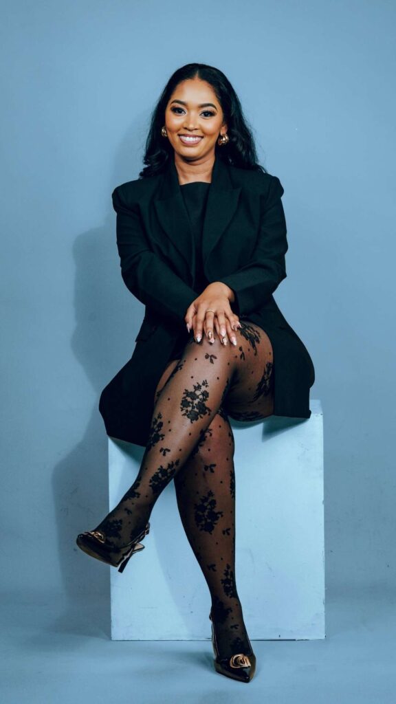 Elegant-outfit-ideas- for-ladies-who-want- to-be-seen-heard-and -addressed-confidently-featuring-a-stylish-woman-wearing-a-black-outfit- with black net-hose-and-black-closed-toe-heels.