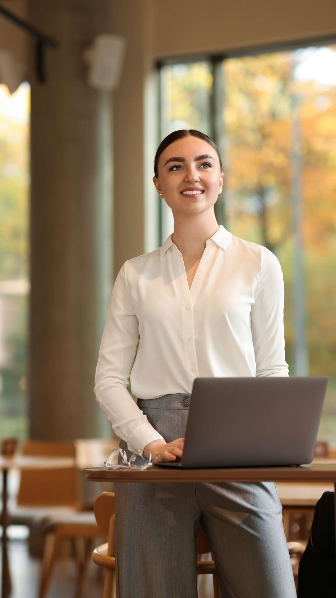 Work-outfits-for-ladies-featuring-a-woman-wearing-a-tucked-in-shirt-paired- with-corporate-trousers-creating-a-clean-and-professional-office-look.