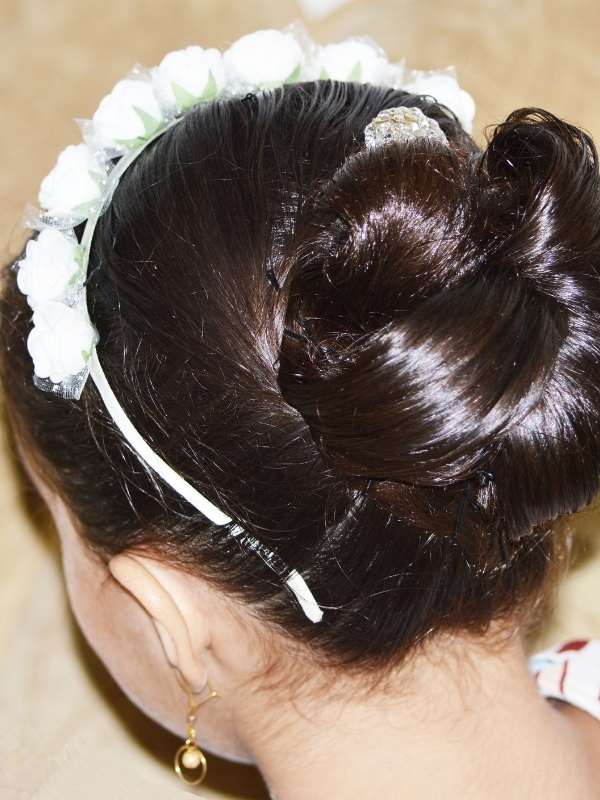Low-bun-hairstyle-with-a-headband-neat-elegant-bun-at-the-nape-of-the-neck-styled-with-a-fashionable-headband-for-a-chic-and-polished-look. 