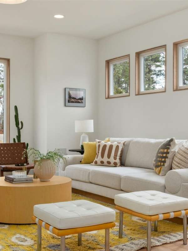 Colorful-living-room-decor-featuring-a-mild-yellow-round-coffee-table-cozy-mixed-yellow-area-rug-ash-gray-couch-and-stylish-accents-creating-an-inviting-modern-aesthetic-space. 
