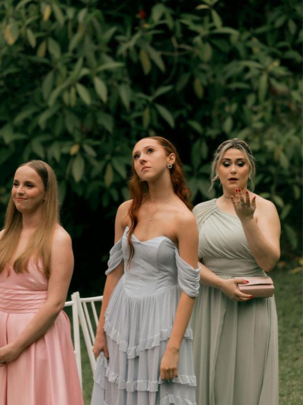 Three-women-wearing-elegant-casual-dresses-for-a-garden-wedding-in-soft-floral-and-pastel