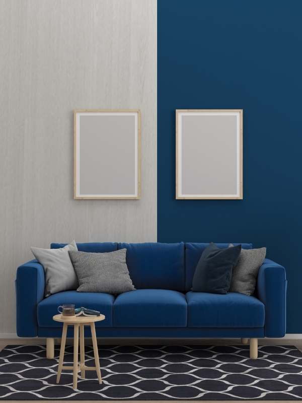  Living-room-featuring-a-navy-blue-accent-wall-paired-with-a-milk-colored-wall-framed-artwork-a-navy-blue-couch-with-matching-pillows-a-black-and-white-area-rug-and-balanced-modern-decor-demonstrating-the influence of color psychology-in