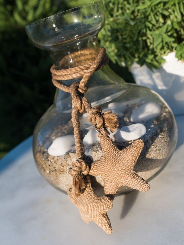 Glass-jar-craft-filled-with-decorative-sand-and-white-stones-to-sell-and-make-profit-from-home.
