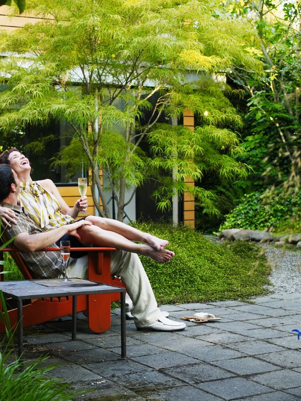 people-relaxing-on-patio-chairs-in-a-small-space-garden