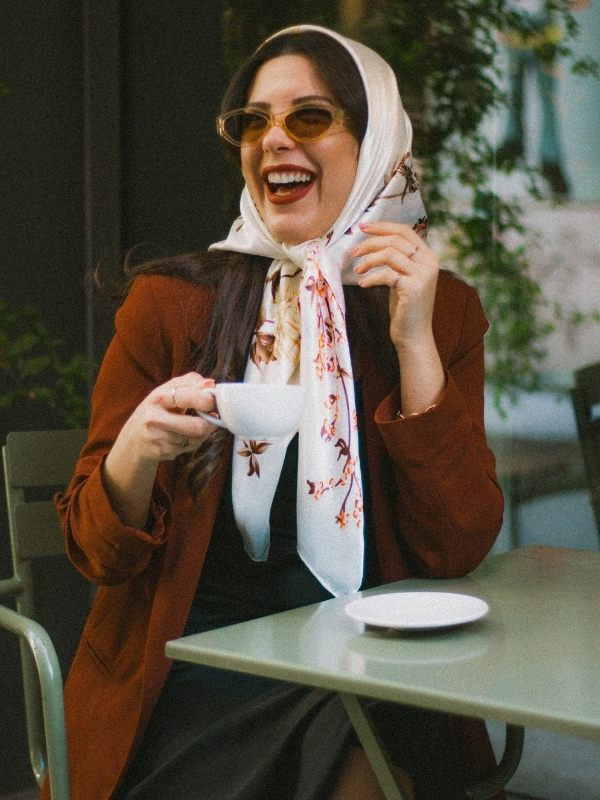 woman-in-vintage-fall-fashion-wearing-brown-coat-and-headscarf-at-cafe