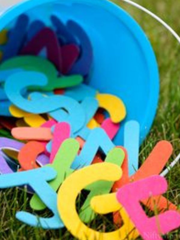 display-of-a-blue-bucket-filled-with-colorful-letters